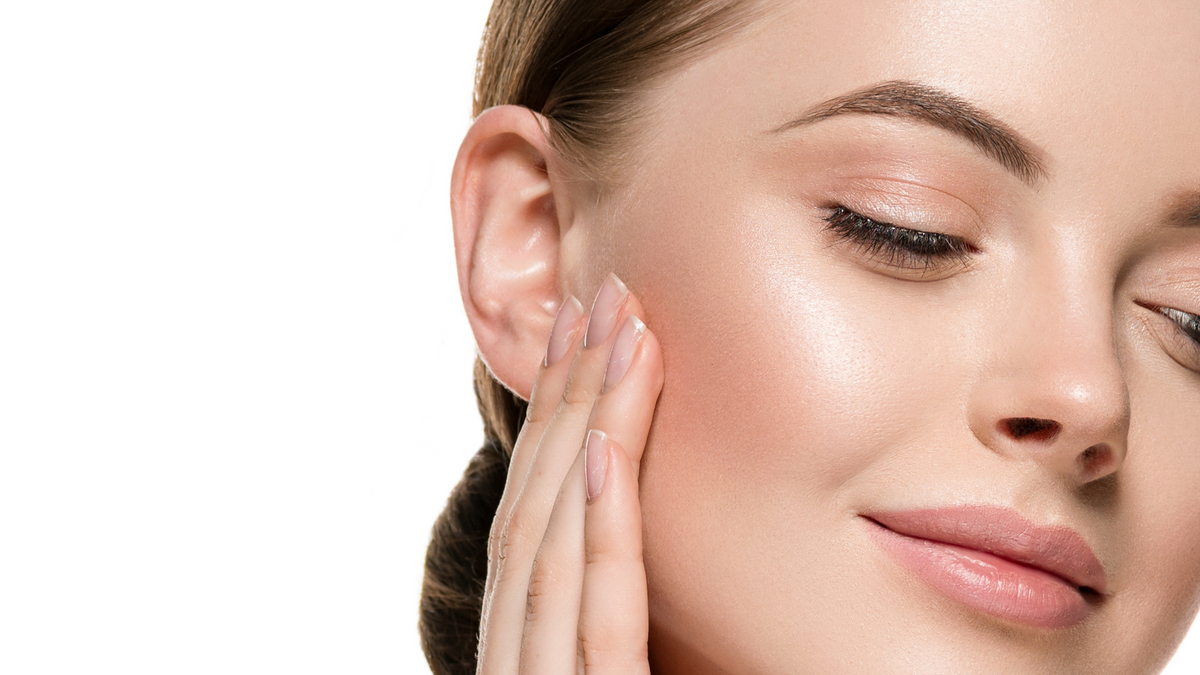 Woman caressing her facial skin.