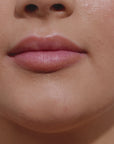 Girl applying lip gloss